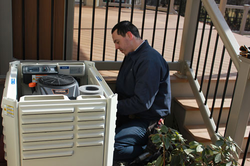 A technician working on a Generac power generator