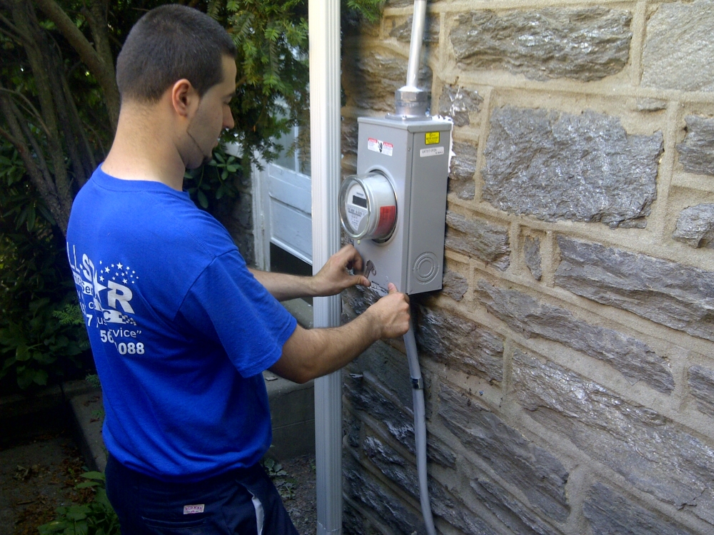 A technician from All Star Electrical Services, LLC working on an electrical panel