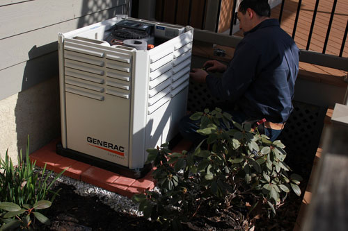 A technician working on a Generac power generator