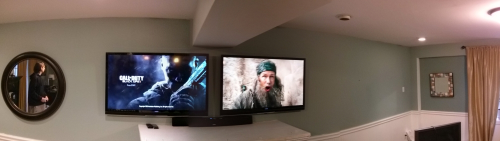 Panoramic shot of a room with two high definition televisions next to each other