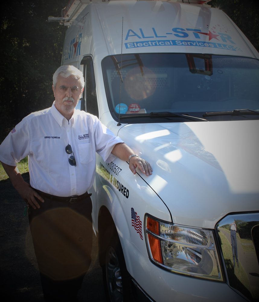 A man posing with the All Star Electrical Services, LLC van