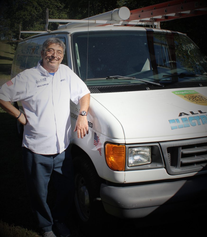 A man posing with the All Star Electrical Services, LLC van