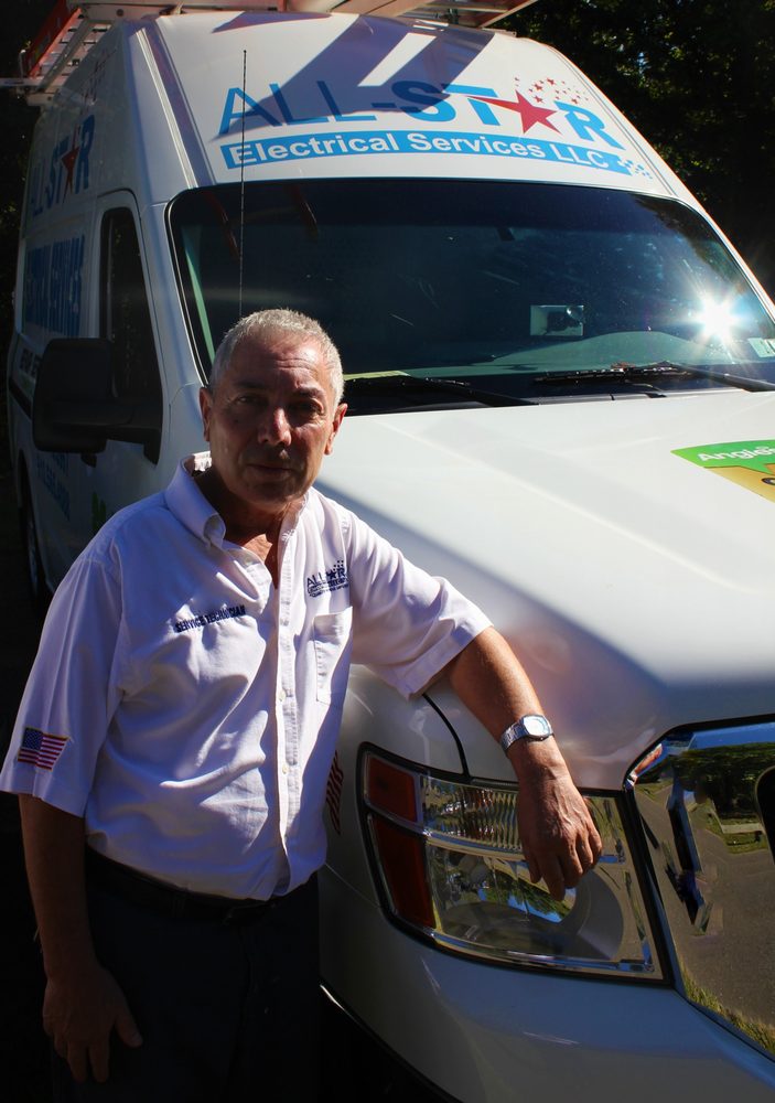 A man posing with the All Star Electrical Services, LLC van