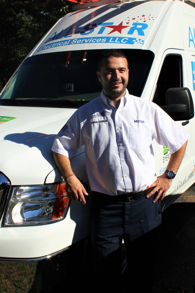 A man posing with the All Star Electrical Services, LLC van