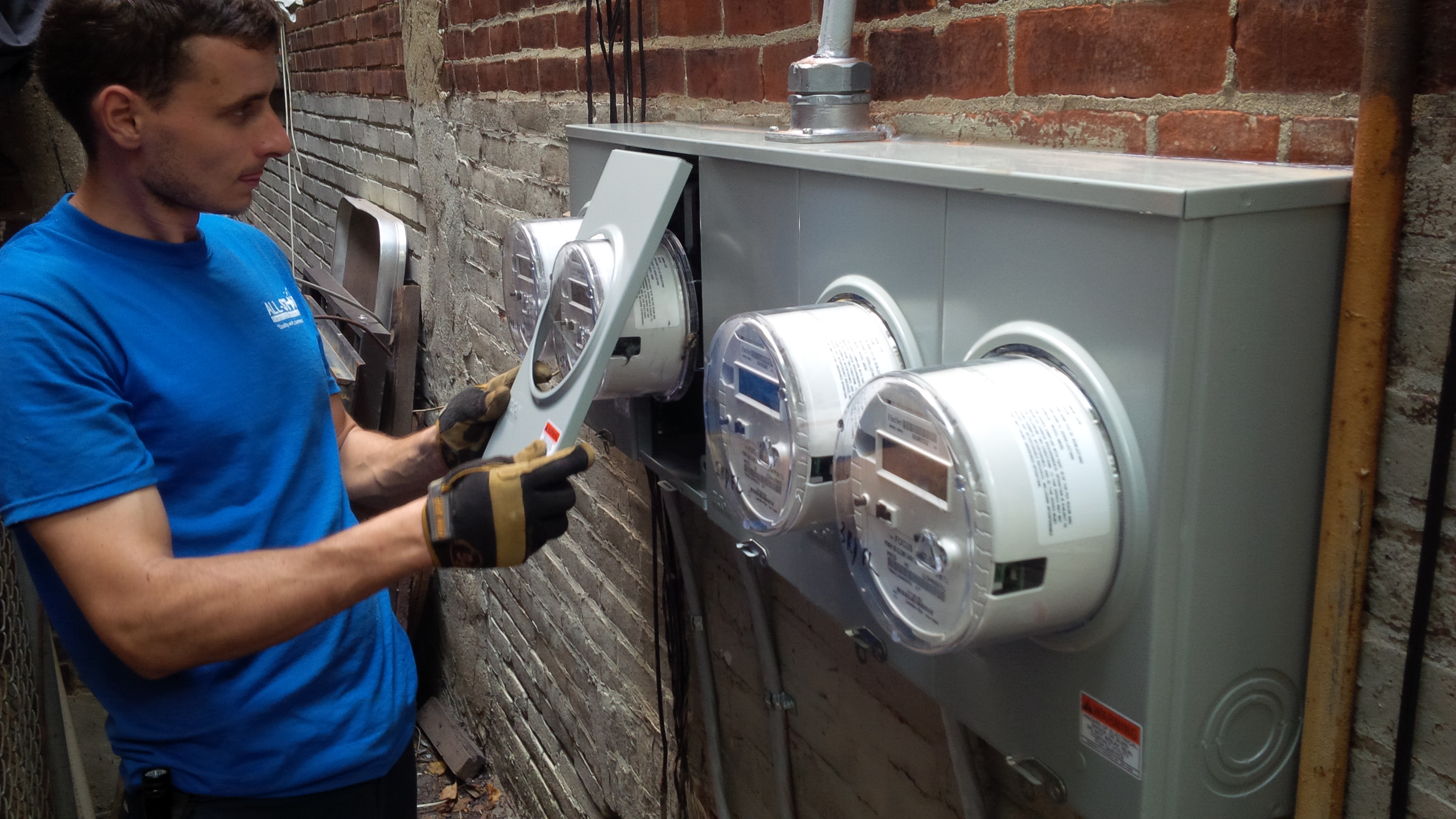 A technician from All Star Electrical Services, LLC working on an electrical panel